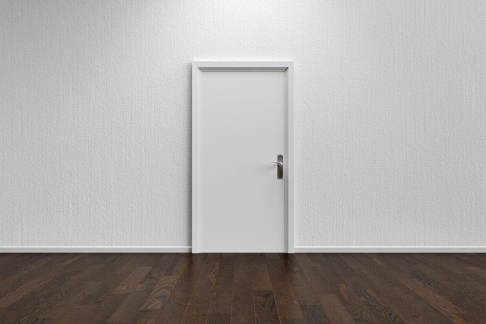 Ein Raum mit weißer Wand, dunklem Holzboden und einer weißen Zimmertür in der Mitte